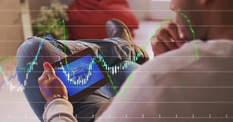 Financial data processing against mid section of man using digital tablet at a Stock Photos