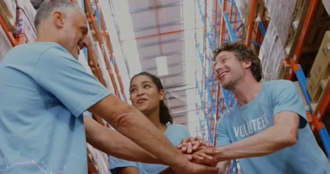 Financial data processing over diverse male and female volunteers stacking their Stock Footage 199311124