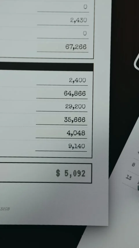 Financial document with amounts of dollars being summed Stock Footage 333445776