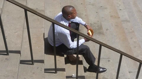 A financial employee eats a bread at Wall Street in New York Video stock 50522403