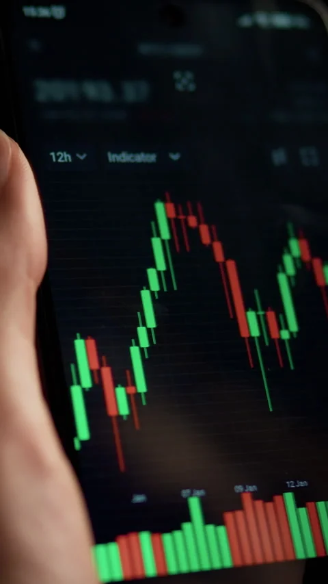 Financial exchange employee analyzes cryptocurrency charts on mobile device Stock Footage 331582004