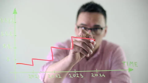 Financial expert makes notes on a glass board Stock Footage 231982498