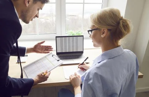 Financial experts analyze data and discuss business strategy with documents in Stock Photos