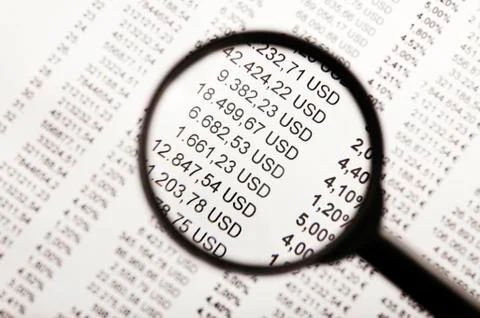 Financial figures under the magnifying glass Stock Photos