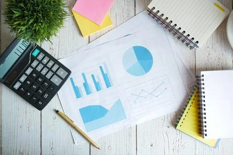 Financial graph, calculator and notepad on table 写真素材