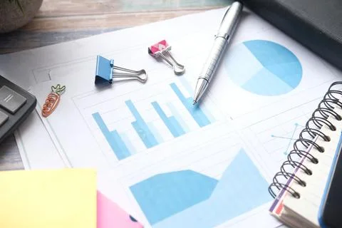 Financial graph, calculator and notepad on table Stock Photos