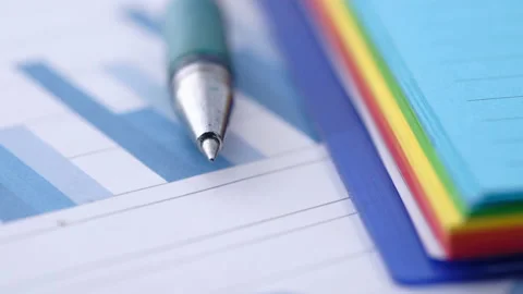Financial graph, pen and notepad on table Stock Footage 141449239