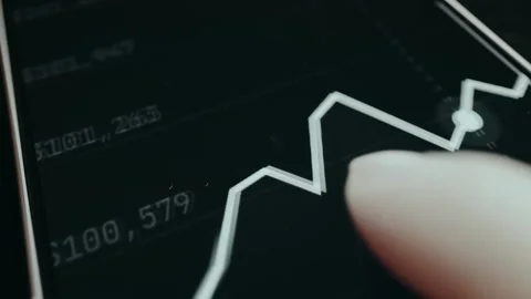 Financial graph showing stock values and a graph tracking a trend over time Stock Footage 332912973