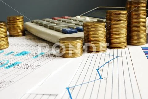Financial growth and business success. Coins, calculator and charts. Stock Photos