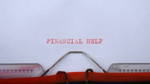 Financial help - phrase printed on an old typewriter in red letters, close up. Stock Footage 129535636