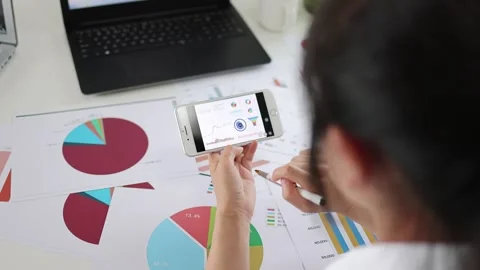 Financial manager studying company performance data chart Stock Footage 253354251