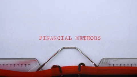 Financial methods - phrase printed on an old typewriter in red letters, close up Stock Footage 129535660
