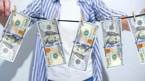 Financial Misconduct Monetary Bills Drying on a Line, Symbolizing Illegal Stock Photos