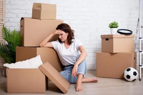 Financial or relationship problems - young stressful woman sitting with cardb Stock Photos