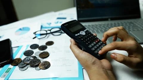 Financial Planning with Calculator and Documents, Person using a calculator.. Stock Footage 304961084