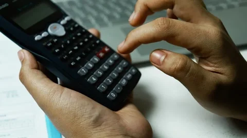 Financial Planning with Calculator and Documents, Person using a calculator.. Video stock 304961095