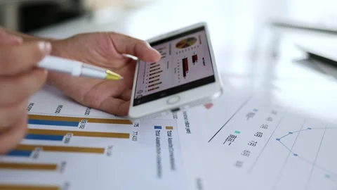 Financial practitioners analyze performance and profit data reports Stock Footage 253355798