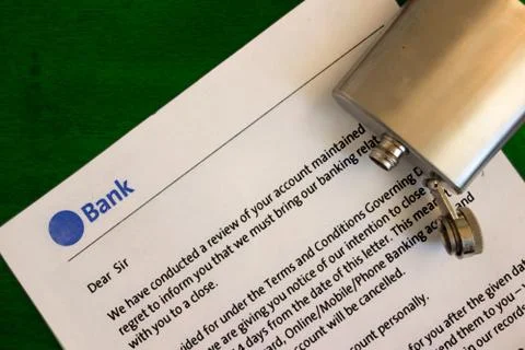 Financial problems concept. Bank notification letter and empty flask on table Stock-Fotos
