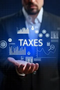 Financial professional analyzing tax data with digital graphics in a modern Stock Photos