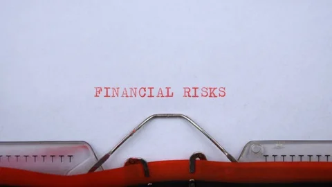 Financial risks - phrase printed on an old typewriter in red letters, close up. Video stock 129535627