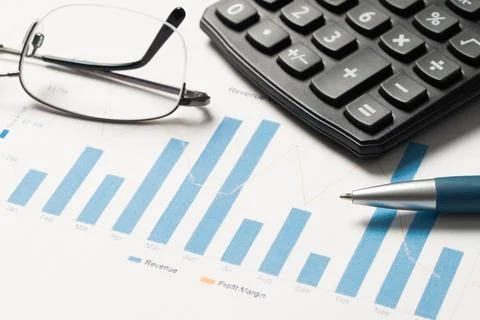 Financial statement or balance sheet summary report with calculator, eye glasses Stock Photos