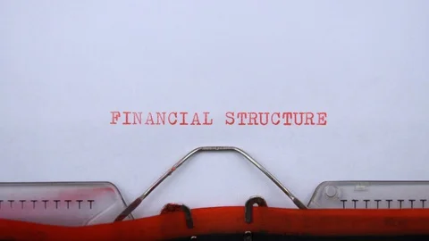 Financial structure - phrase printed on an old typewriter in red letters Stock-Footage 129535710