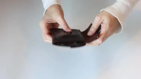 Financial Struggle: Shaking an Empty Wallet Stock Footage 329440719
