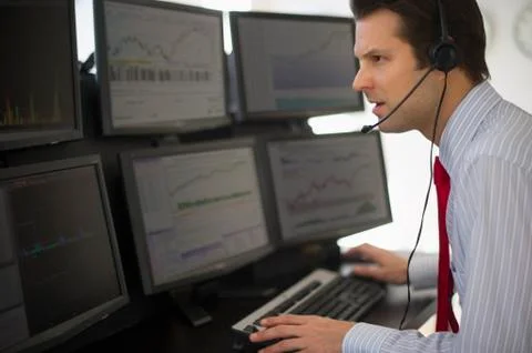 Financial worker analyzing data displayed on computer screen Stock Photos