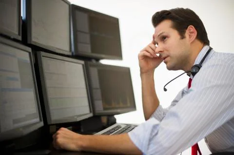 Financial worker analyzing data displayed on computer screen Foto stock