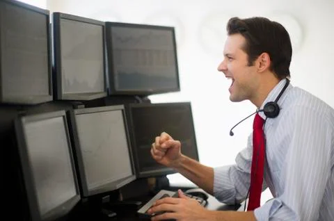 Financial worker analyzing data displayed on computer screen Stock Photos