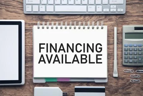 Financing Available text in notepad with a business objects. Stock Photos