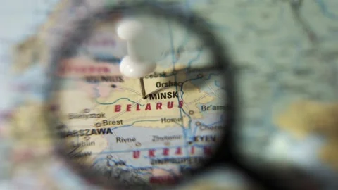 Find Minsk on a world map using a magnifying glass Stock Footage 339303748