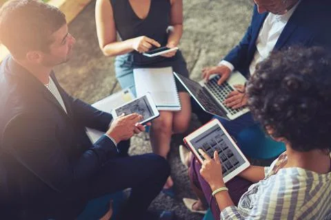 Find out how technology can transform your business. High angle shot of a group Stock Photos