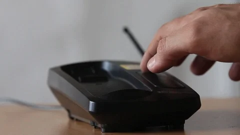 Find the phone and put it on the base Stock Footage 97249604
