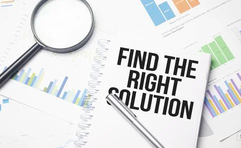 Find The Right Solution text on white notebook and pen on wooden background Stock Photos