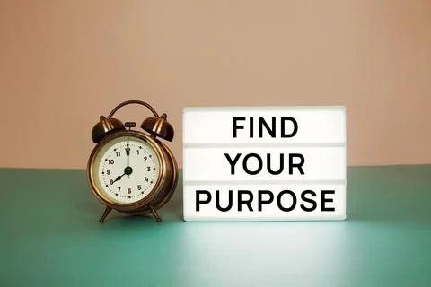 Find Your Purpose text message on paper card with wooden easel and alarm cloc Stock Photos