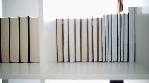 Finding book on a bookshelf Stock Footage 84293716