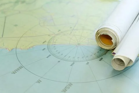 Finding coordinates. Shot of nautical maps on a table. Stock Photos