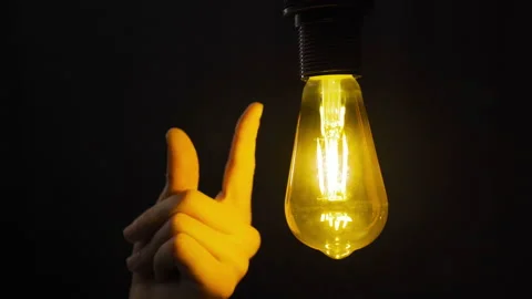 Finding ideas. Snap a finger and the lamp turns on. Stock Footage 223827493