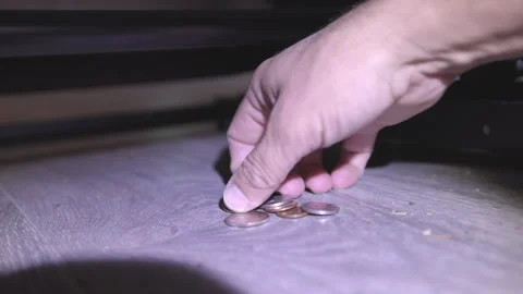 Finding Loose Change Under the Couch with a Flashlight Stock Footage 314392267