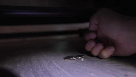 Finding Loose Change Under the Couch with a Flashlight Stock Footage 314392437