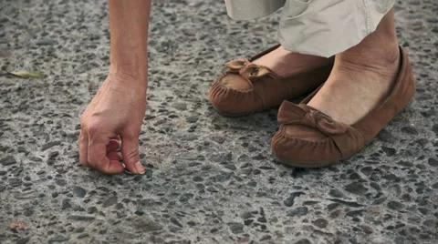 Finding a Lost Nickel on the Street Stock Footage 11440403