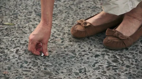 Finding a Lost Quarter on the Street Video stock 11440686