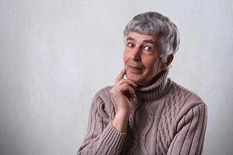 Finding perfect solution. Mature handsome man with gray hair and wrinkles hol 写真素材