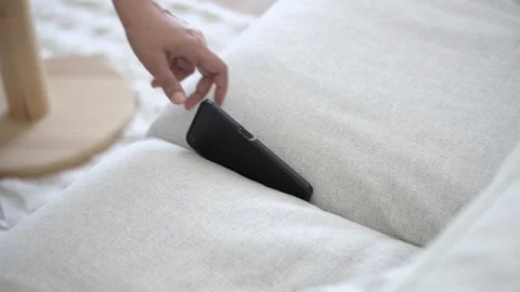 Finding a phone in the couch at home. smart phone stuck in a couch Stock Footage 336770343