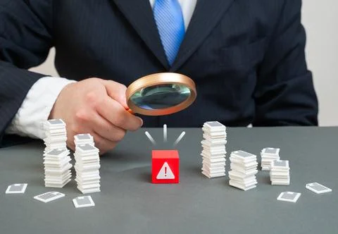 Finding a problem among numerous reports and documents. A bureaucratic mine.. Stock Photos