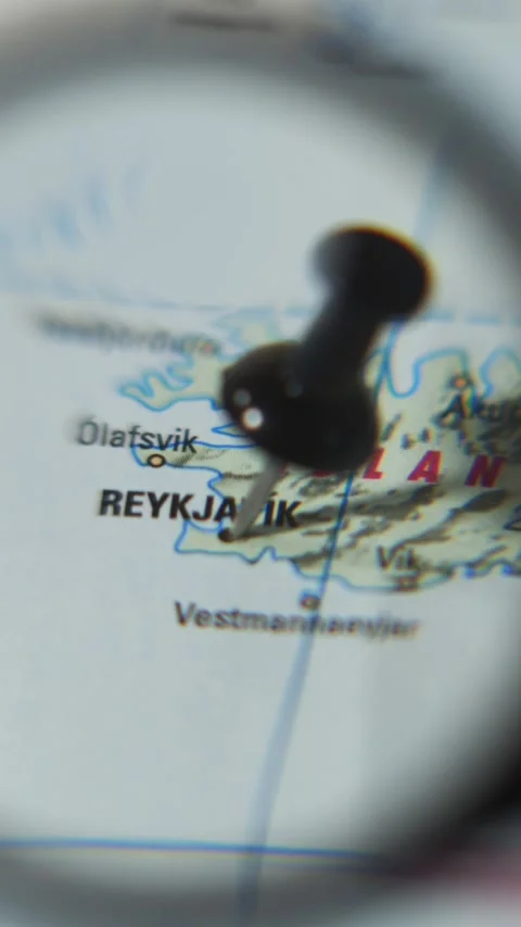 Finding Reykjavik on a world map using a magnifying glass Stock Footage 339303743