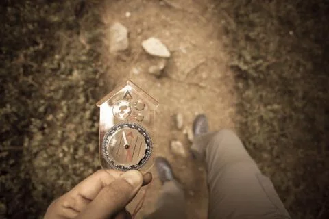 Finding the right position in the forest with a compass, vintage effect Stock Photos