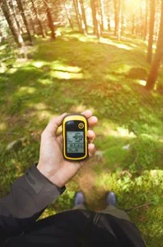 Finding the right position in the forest via gps Stock Photos