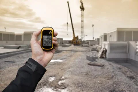 Finding the right position inside a construction site via gps ( blurred backg Stock Photos